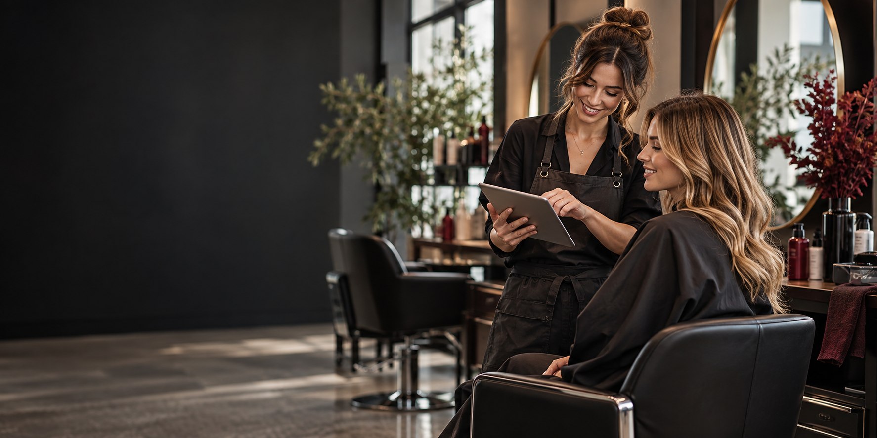 Salon stylist helping a customer review an appointment